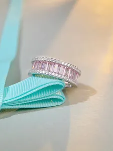 Close-up of S925 silver eternity ring with pink emerald-cut stones and pavé diamonds