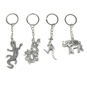 Detailed view of four vintage silver alloy animal keychains featuring dragon and elephant