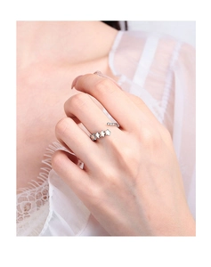 Detail of silver vintage star ring on finger featuring open band and star patterns