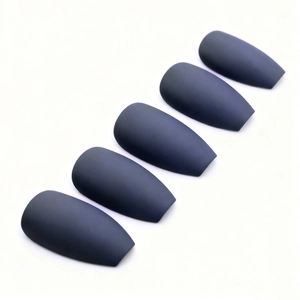 Five pieces of matte navy blue coffin-shaped press-on nails shown on a grey background