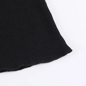Detailed macro view of black ribbed knit fabric texture and high-quality stitching