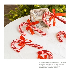 Detail of red and white candy cane ornaments with ribbon bows for Christmas tree decor