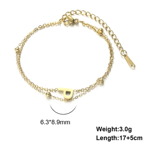 Detail of gold double-layer stainless steel bracelet with letter P pendant and golden beads