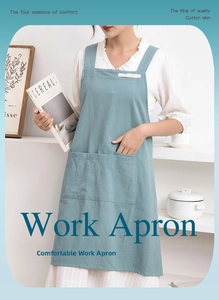 Detail of blue-gray cotton linen apron featuring large pockets and cross-back straps