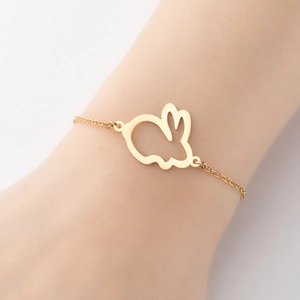 Minimalist gold hollow rabbit bracelet on wrist featuring a delicate metal chain design