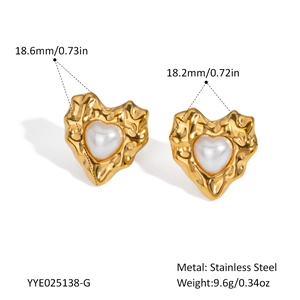 Detail view of heart-shaped gold steel earrings with pearls and size measurements