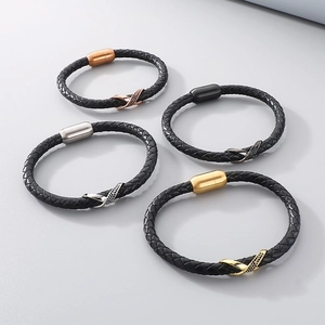 Close-up of leather bracelets with magnetic clasps and stone-set infinity charms