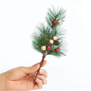 Mini Christmas pine branch with red berries and golden pine cones on white background