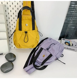 Detail of lightweight nylon sports chest bags in bright yellow and light purple colors