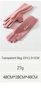 Detail of coral pink thermal half-finger gloves with knit texture and fashion print