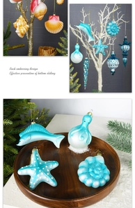 Detail of ocean-themed glass Christmas ornaments on a white tree with starfish and octopus