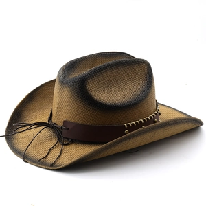 Vintage brown straw cowboy hat with black gradient brim and studded leather band