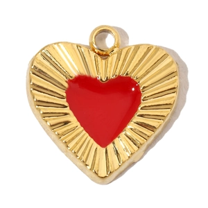 Detailed view of heart-shaped gold-plated pendant with red enamel inlay and radial pattern