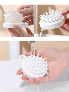 Close-up of detachable white silicone scalp massager brush with easy-to-clean design