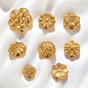 Gold stainless steel flower spacer beads on white silk for jewelry making DIY