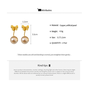 Detail view of pearl bow earrings with product dimensions and silver needle material info