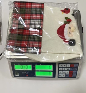 Weight measurement of a linen Christmas stocking with Santa Claus and red plaid design