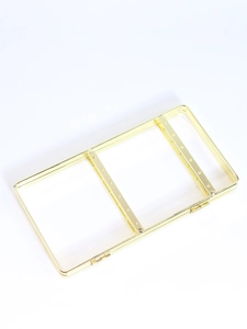 Macro detail of golden metal jewelry display rack with precision holes for earrings