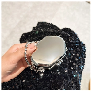 Macro shot of silver mirrored mini crossbody bag with chic bead chain handle