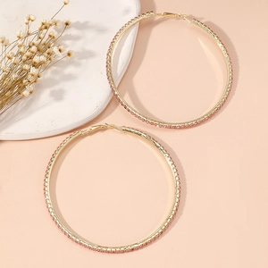 Macro shot of 8cm gold hoop earrings with sparkling pink rhinestones and clasp detail