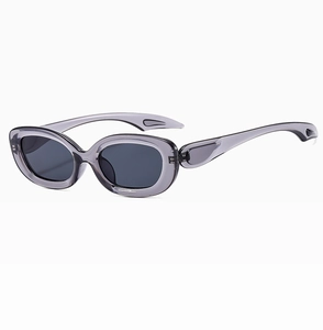 Detail of grey translucent oval sunglasses frame with streamlined hollow temple design