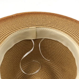 Inside view of a hand-woven straw jazz sun hat with adjustable white ribbon and sweatband