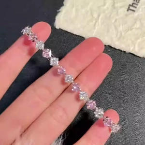 Diamond-shaped star charm bracelet with alternating pink and white cubic zirconia stones