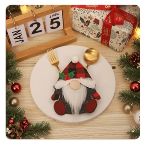 Close-up of Christmas gnome cutlery holder with red plaid design on a white plate