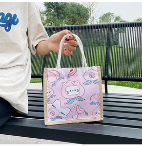Close-up of pink canvas tote bag with peach cat print and sturdy cotton rope handle