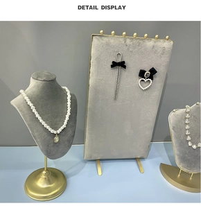 Detail display of pearl necklace and velvet bow earrings on jewelry display stand