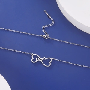 Detail view of silver infinity Mom pendant necklace on a blue and white background
