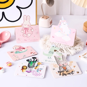 Animal-themed cartoon greeting card set with rabbit and lion designs on desk