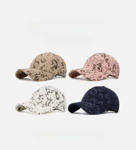 Close-up of leopard print baseball caps in four colors including khaki, pink, and navy