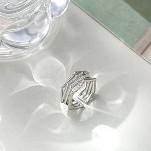 Macro shot of a layered silver geometric ring with shimmering cubic zirconia settings