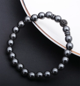 Macro detail of hematite beaded bracelet featuring a black micro-pave zircon ball