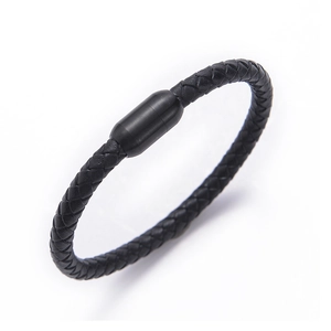 Macro shot of black braided leather bracelet with a magnetic stainless steel cylinder clasp