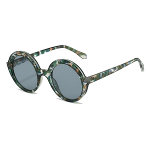 Stylish round thick-frame sunglasses with green and blue marble pattern and dark grey lenses