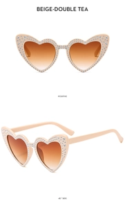 Detail of beige heart-shaped sunglasses with rhinestone accents and gradient tea lenses