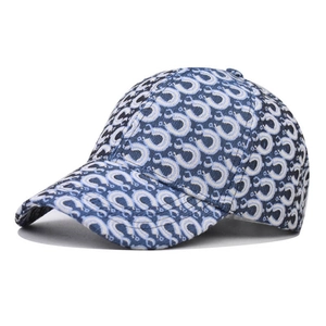 Detailed view of the navy blue baseball cap with white geometric monogram print pattern