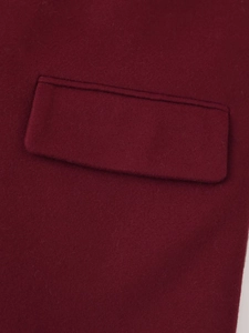 Close-up of the burgundy wool coat pocket detail showing fine stitching and thick fabric