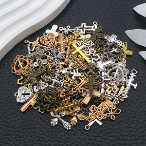 Gedetailleerde macro-opname van diverse vintage kruishangers in goud, zilver en brons