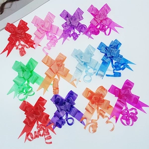 Flat lay of 18mm colorful plastic gift bows with gold edges in various vibrant colors