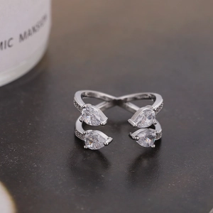 Minimalist silver crossover ring with pear-cut cubic zirconia and pavé stones