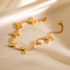 Elegant 18K gold plated stainless steel butterfly charm bracelet on beige silk