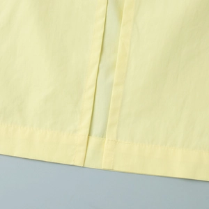 Close-up of high-quality double stitching and texture on yellow summer skirt set