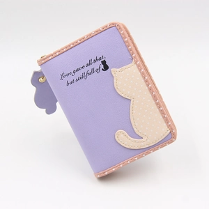 Detail of purple PU leather cat wallet featuring beige polka dot cat silhouette and zip pull