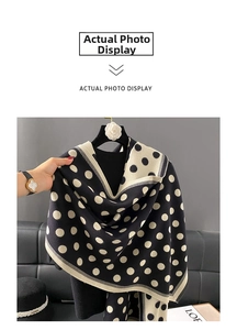 Detail view of the thick knit texture and classic polka dot pattern on this warm shawl