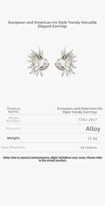 Detail of wing-shaped silver alloy earrings with sparkling crystal rhinestones