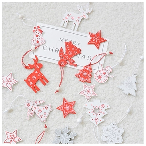 Close-up of wooden Christmas ornaments with snowflake patterns on white faux fur background