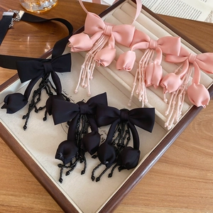 Choker necklaces with fabric bows, flowers, and beaded tassels in black and pink colors